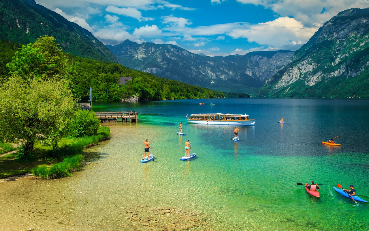 Active friends kayaking and paddling on the sup boards, Slovenia